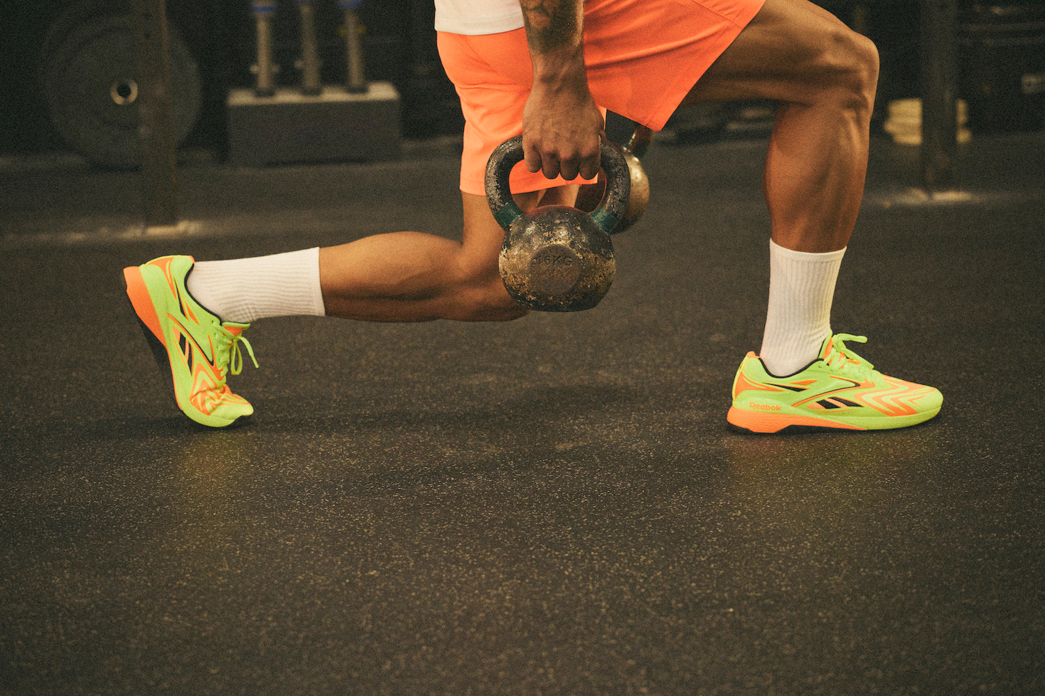 Christian Harris does kettlebell lunges in his Nano X5 Edge training shoes