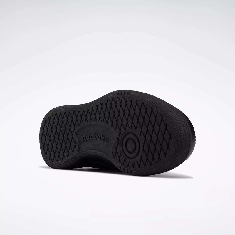 The image shows the black rubber sole of Reebok Kids' Club C Shoes - Little Kids, viewed from the bottom. The sole has a diamond tread pattern with the Reebok logo and branding in the center.