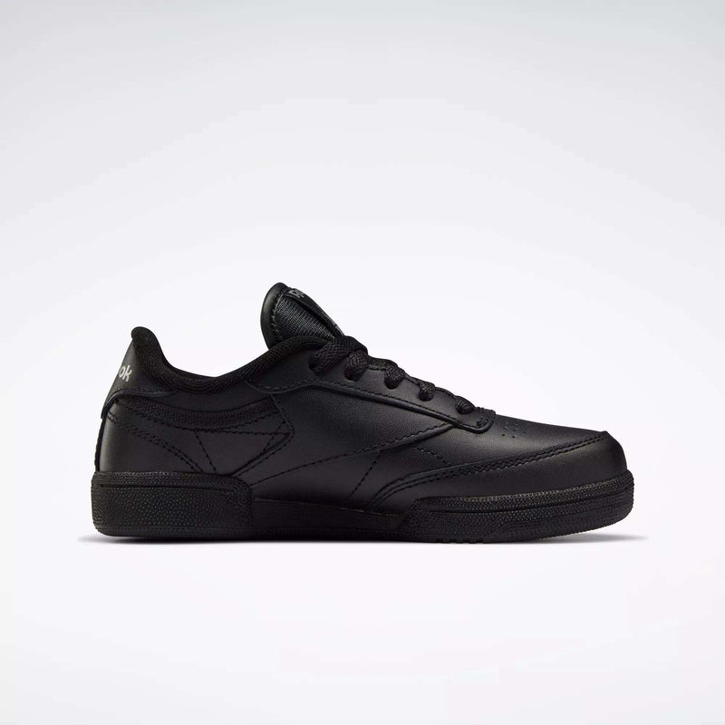The Reebok Kids' Club C Shoes - Little Kids feature a black leather upper, black laces, subtle stitching details, and a simple low-top design, displayed on a plain white background.