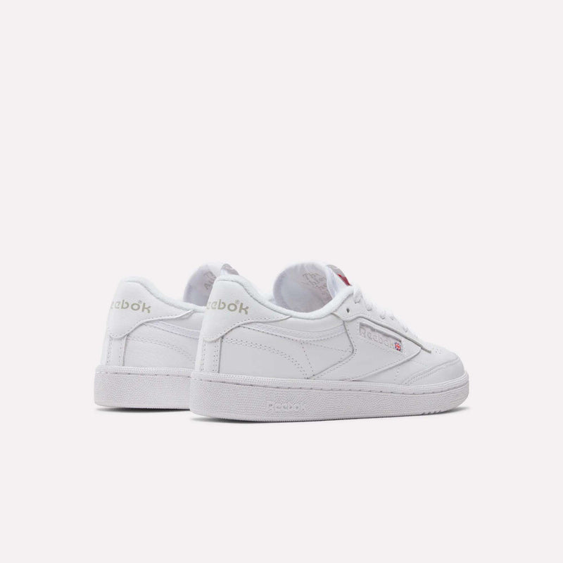The Reebok Women's Club C 85 Shoes are classic white low tops with side and back logos plus flat soles, shown on a plain white background—ideal for fans of timeless style.