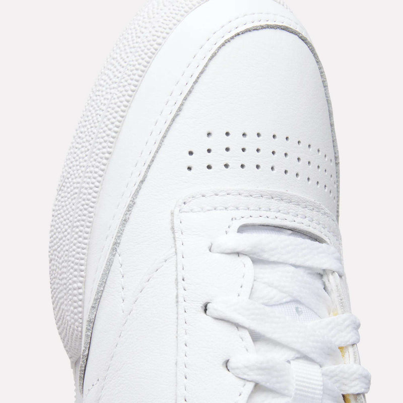 Close-up of the toe and laces on the Reebok Women's Club C 85 Shoes, highlighting perforated details on the toe box, a textured rubber sole, and white stitching on smooth leather.