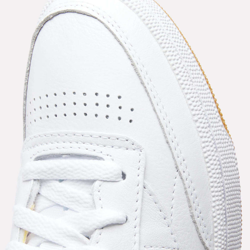Close-up of the toe and laces on the Reebok Women's Club C 85 Shoes, showcasing perforated details, a textured sole, and visible stitching.