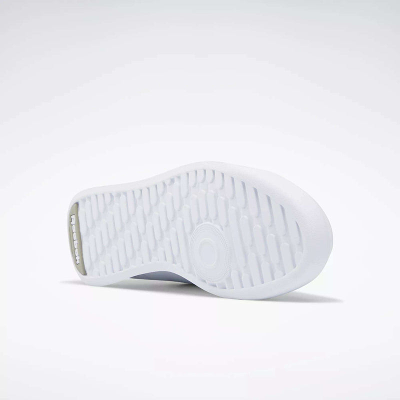The image shows the white rubber outsole of Reebok Women's Princess Shoes, featuring a textured grip pattern and the Reebok logo embossed near the heel against a plain, light background.