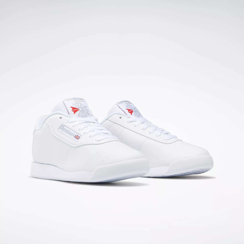 The Reebok Women's Princess Shoes feature a classic low-top design with lace-up fronts and subtle Reebok branding on the sides, tongue, and heel, highlighting heritage style against a plain white background.