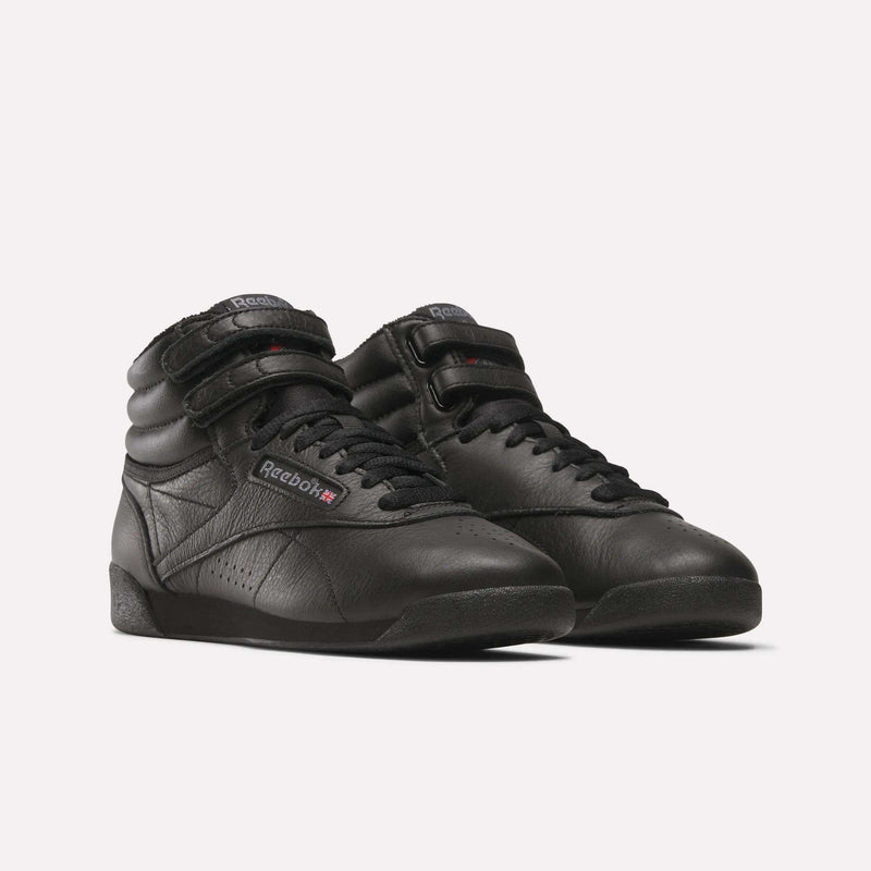 The Women's Freestyle Hi Shoes by Reebok feature a black high-top design with Velcro straps and leather uppers, ideal for women's fitness, shown against a plain white background.