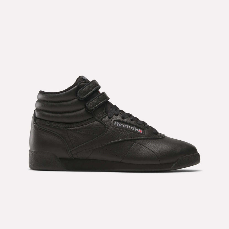The Reebok Women's Freestyle Hi Shoes are black high-top sneakers with a leather upper, dual ankle Velcro straps, black laces, and a side Reebok logo—ideal for women's fitness. Shown against a plain white background.