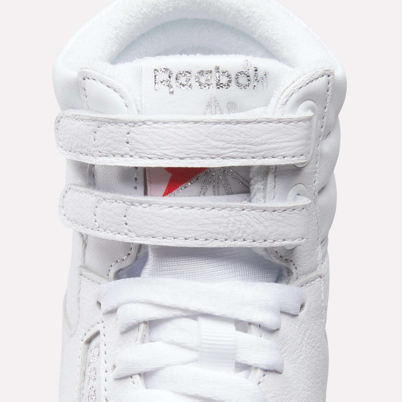 Close-up of the Reebok Women's Freestyle Hi Shoes, featuring two Velcro straps, white laces, and the classic Reebok logo on the tongue—ideal high top sneakers for fitness or stylish everyday wear.