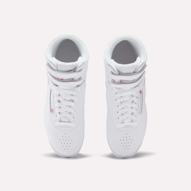 A pair of Reebok Women's Freestyle Hi Shoes is shown from above on a plain white background. Designed for women's fitness, these high-top sneakers feature perforated toes and neatly tied laces.