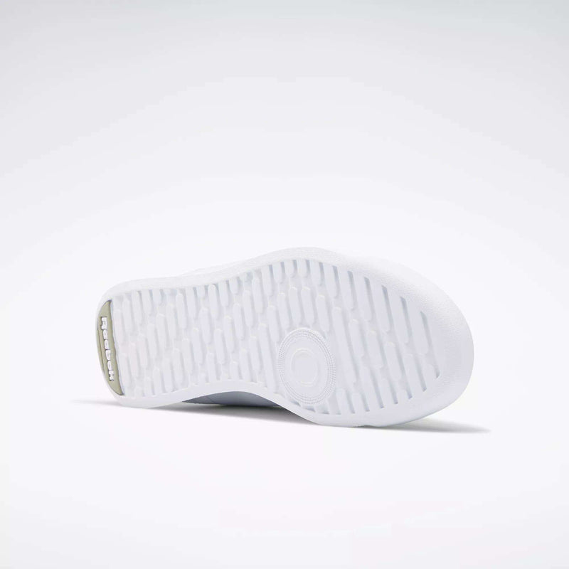 The image displays the white rubber sole of Reebok Women's Princess Wide Shoes, featuring a textured tread and central circular design, set against a plain light gray background.