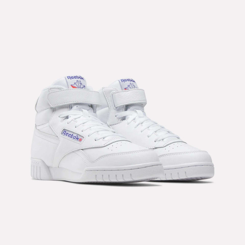A pair of Men's EX-O-FIT Hi Shoes by Reebok, white high-top leather sneakers with velcro straps and classic blue and red logos on the side and tongue, featuring a vintage design, shown on a plain white background.