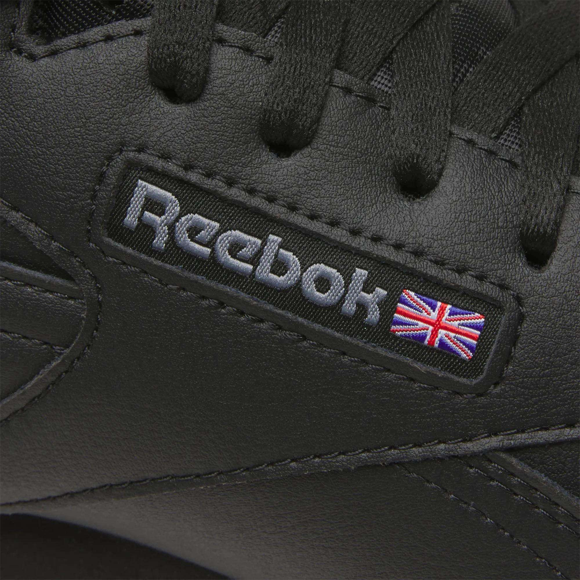 A close-up of Reebok Men's EX-O-FIT Hi Shoes, highlighting their retro leather design.
