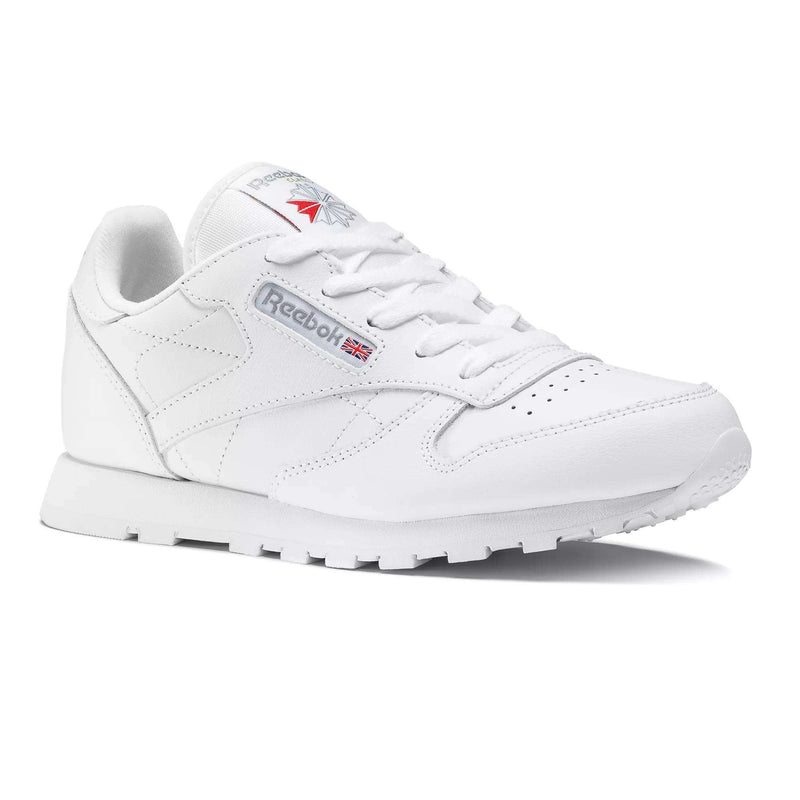 The Reebok Kids' Classic Leather Shoes - Preschool features a white leather upper, low-top design, visible stitching, lace-up front, and Reebok branding with the UK flag on the side and tongue, displayed on a plain white background.
