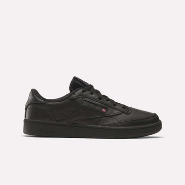 The Reebok Club C 85 Shoes feature a black low-top design with a textured leather upper, black laces, and a black rubber sole. Subtle black and purple Reebok logos on the side add a classic touch for fans of timeless leather footwear.