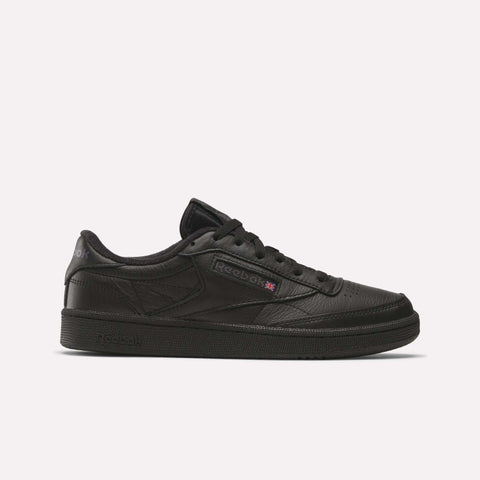 The Reebok Club C 85 Shoes feature a black low-top design with a textured leather upper, black laces, and a black rubber sole. Subtle black and purple Reebok logos on the side add a classic touch for fans of timeless leather footwear.