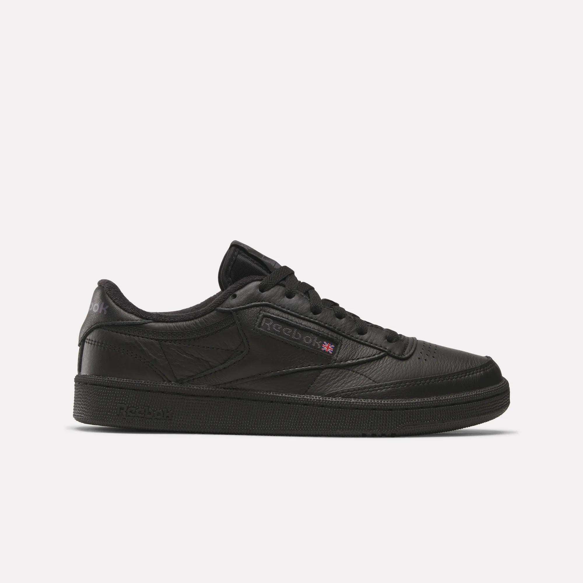 The Reebok Club C 85 Shoes feature a black leather upper, black sole, and black laces in a low-top design, shown in side profile on a plain white background.