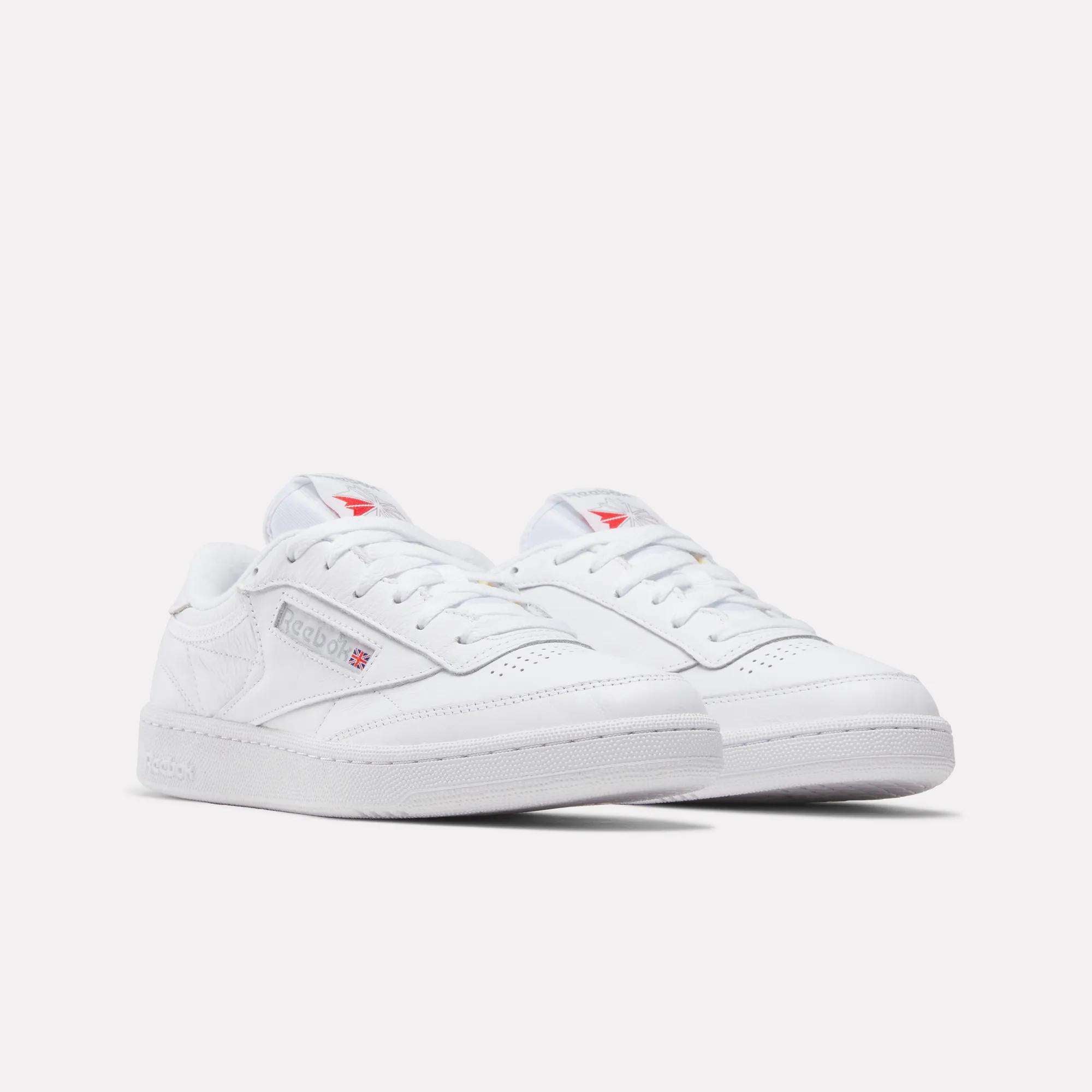 A pair of Reebok Club C 85 Shoes in white leather with white laces, subtle gray branding, and small red accents, shown on a plain white background.
