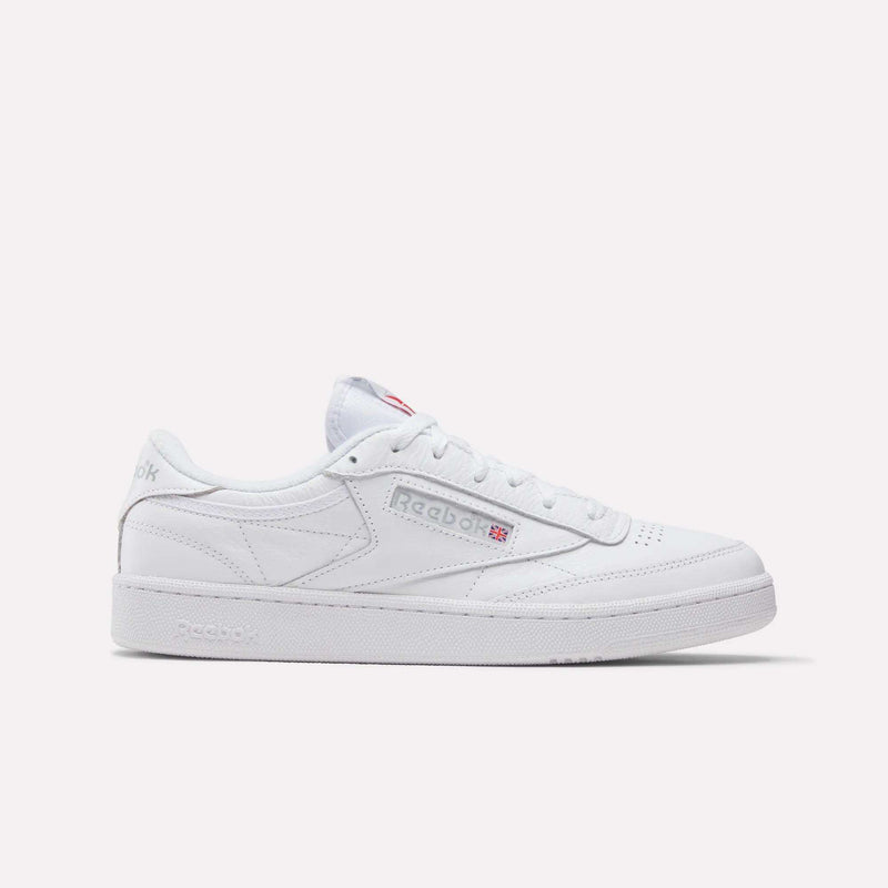 The Reebok Club C 85 Shoes feature a white leather upper with gray stitching, low-top tennis-inspired design, Reebok logo with Union Jack on the side, and white laces and sole against a plain background.
