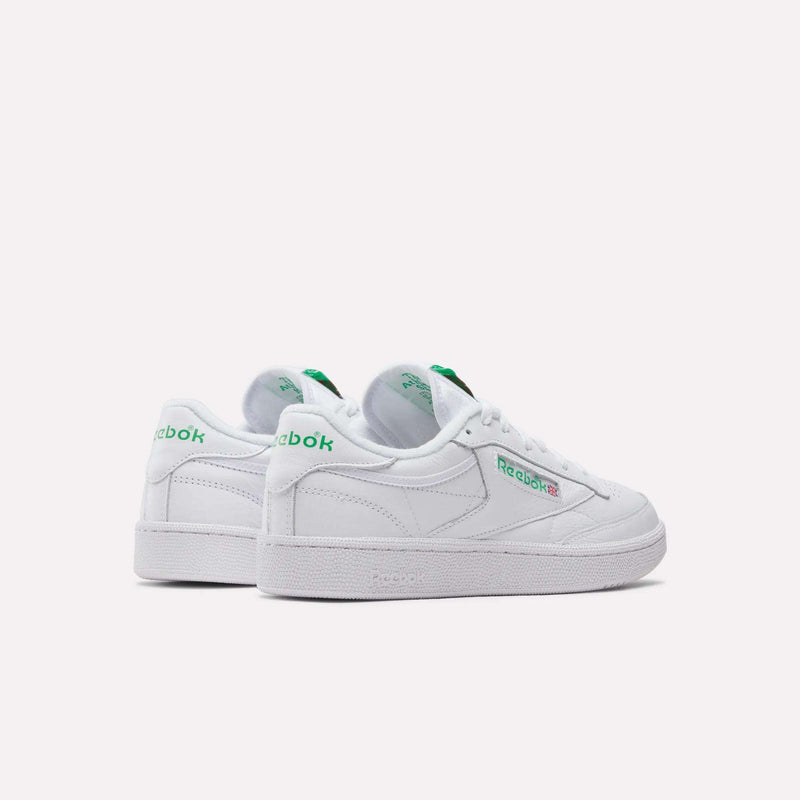 A pair of Reebok Club C 85 Shoes in white leather with green accents, featuring the Reebok logo on the sides and heel, displayed on a plain light background.