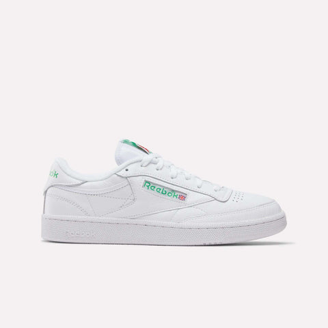 The Reebok Club C 85 Shoes feature a white low-top design with green and red logo accents on the side and tongue, white laces, and are displayed against a plain light background.