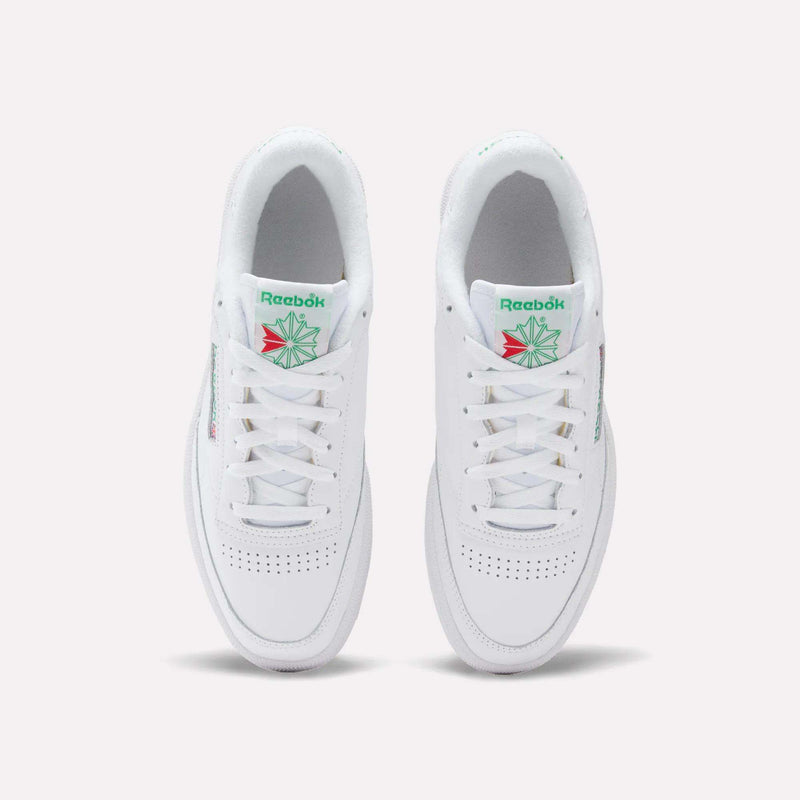 A top view of Reebok Club C 85 Shoes shows white sneakers with white laces, perforated toe area, and green and red logo details on the tongue.