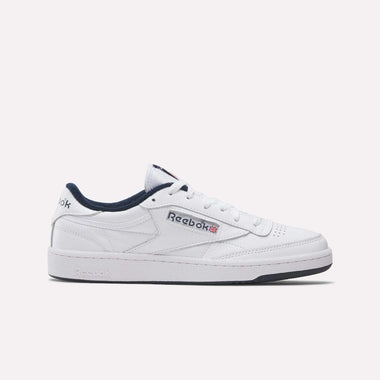 The Reebok Club C 85 Shoes are white leather low-tops with black accents on the collar and sole, Reebok logo on the side, perforated toe details, and side stitching inspired by classic tennis style.