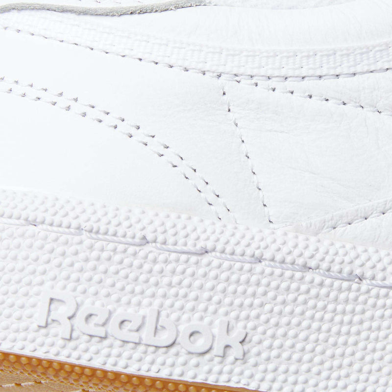 Close-up of the Reebok Club C 85 Shoes, showcasing detailed stitching on the white leather upper and the embossed Reebok logo on the textured rubber sole.