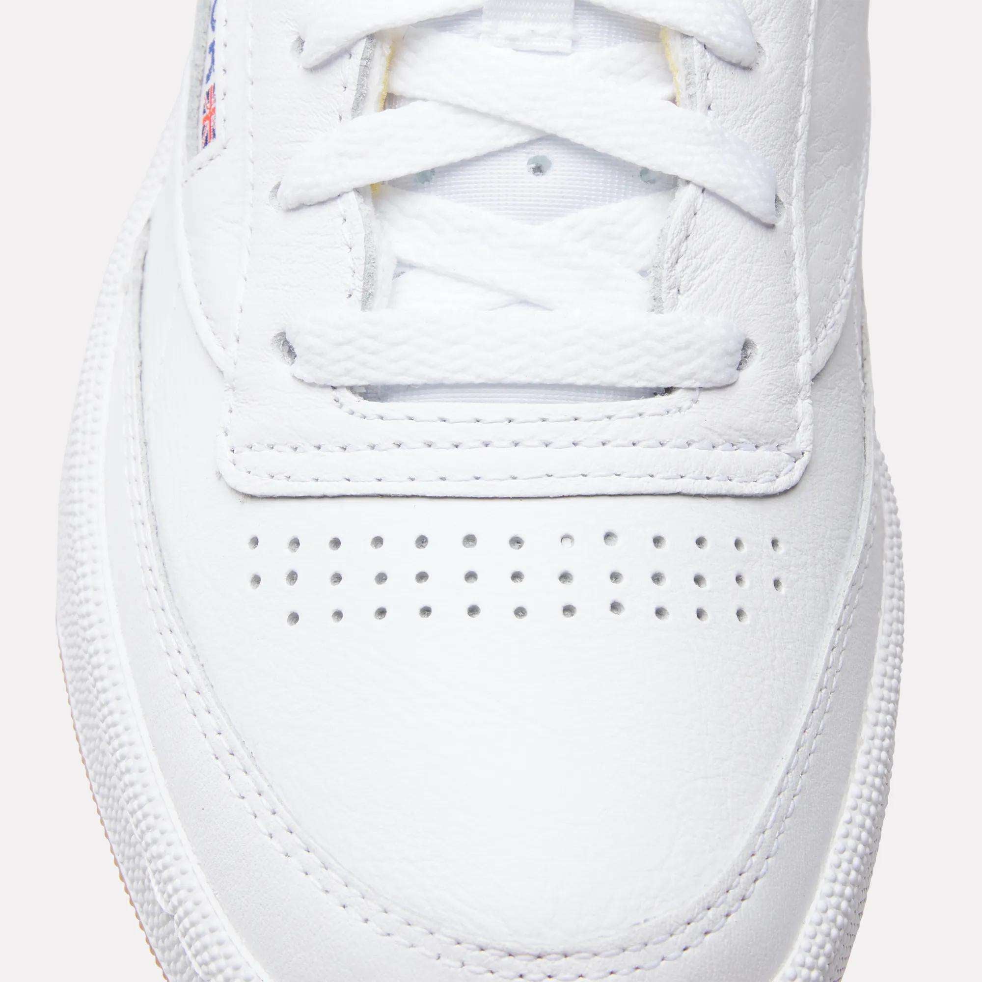 Close-up of the toe and laces on Reebok Club C 85 Shoes, highlighting detailed stitching, a row of small ventilation holes, and textured white leather.