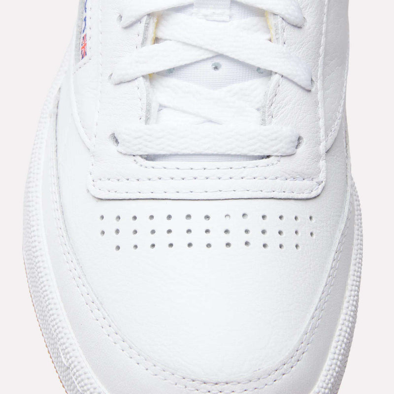 Close-up of the toe and laces on Reebok Club C 85 Shoes, highlighting detailed stitching, a row of small ventilation holes, and textured white leather.