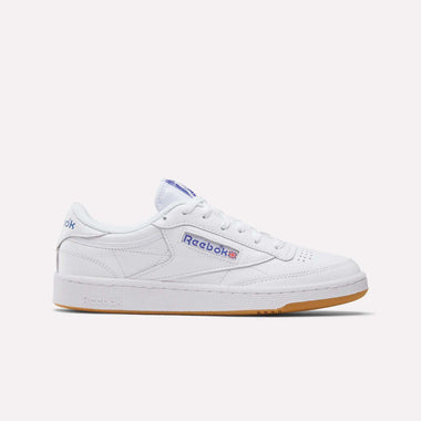 The Reebok Club C 85 Shoes feature a white upper, gum sole, blue Reebok logo, and red-white-blue Union Jack on the side, shown against a plain white background.
