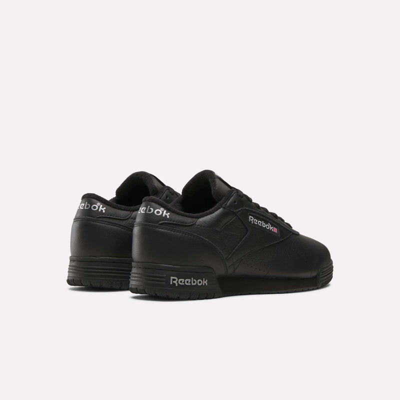 The Reebok Men's Exofit Lo Shoes are black low-top sneakers, shown from the back and side, displaying the Reebok logo in white and red on the side and heel against a plain white background.
