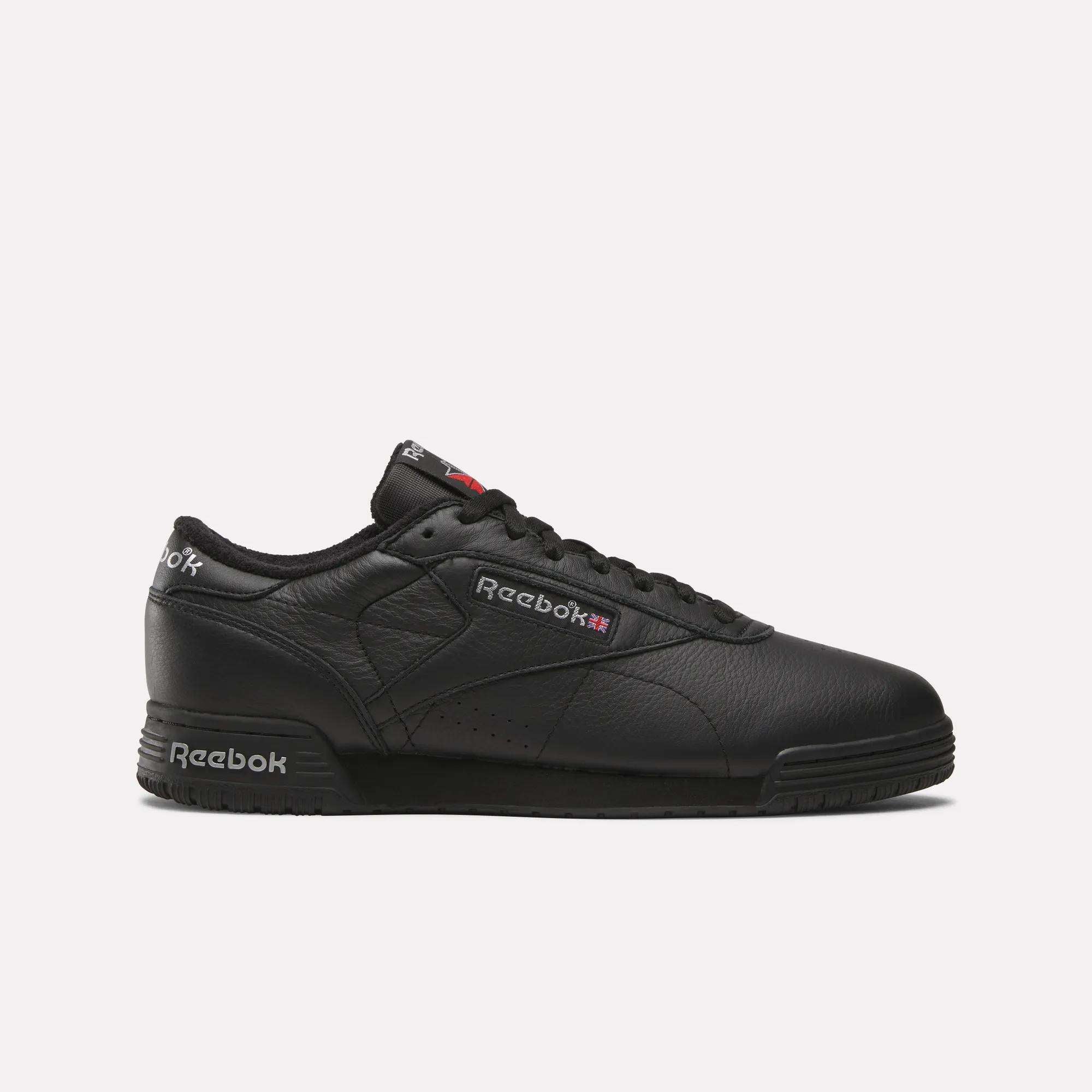 The Reebok Men's Exofit Lo Shoes feature a black low-top design with a leather upper, black sole, and subtle logos on the side, tongue, and heel, all shown against a white background.