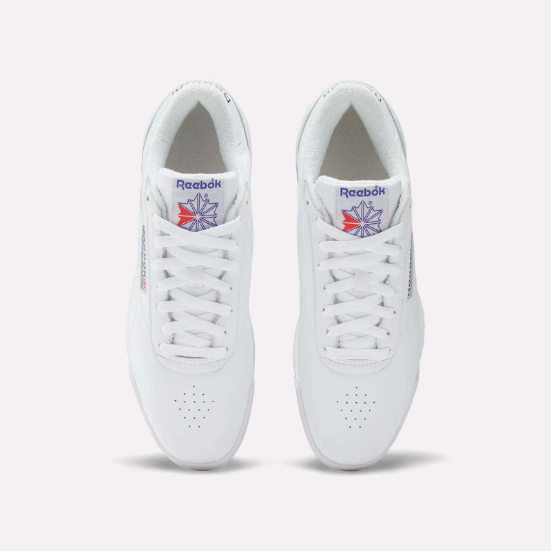 A pair of white Reebok Men's Exofit Lo Shoes shown from above, featuring the Reebok logo and a red and blue starburst design on the tongue.
