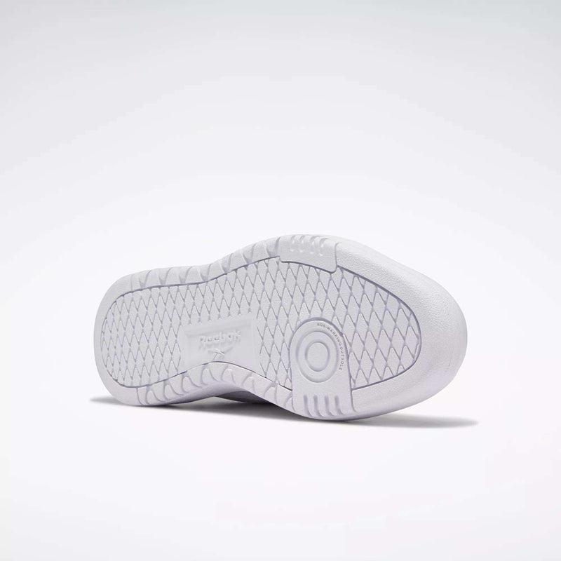 The image displays the white rubber sole of Reebok Women's Club C Double Shoes, showcasing a diamond-patterned tread and a circular detail near the heel, photographed against a plain light background.
