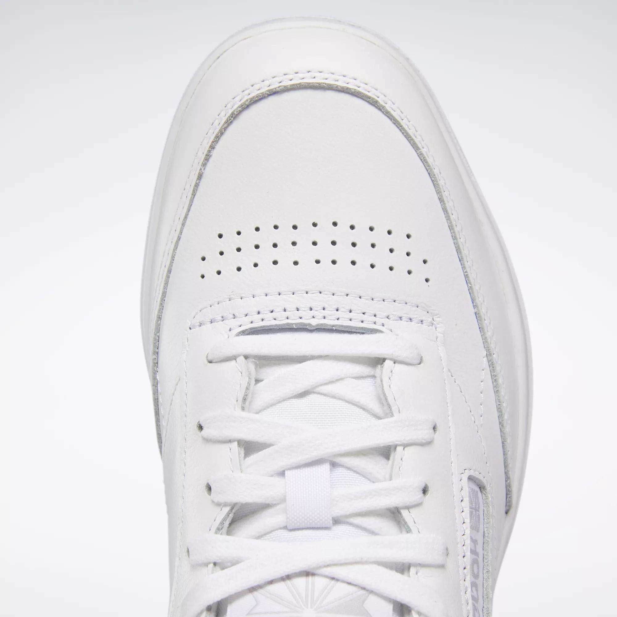 Close-up of the Reebok Women's Club C Double Shoes featuring a white tennis-inspired design, smooth leather upper, toe box, white laces, perforated holes for ventilation, and detailed stitching.