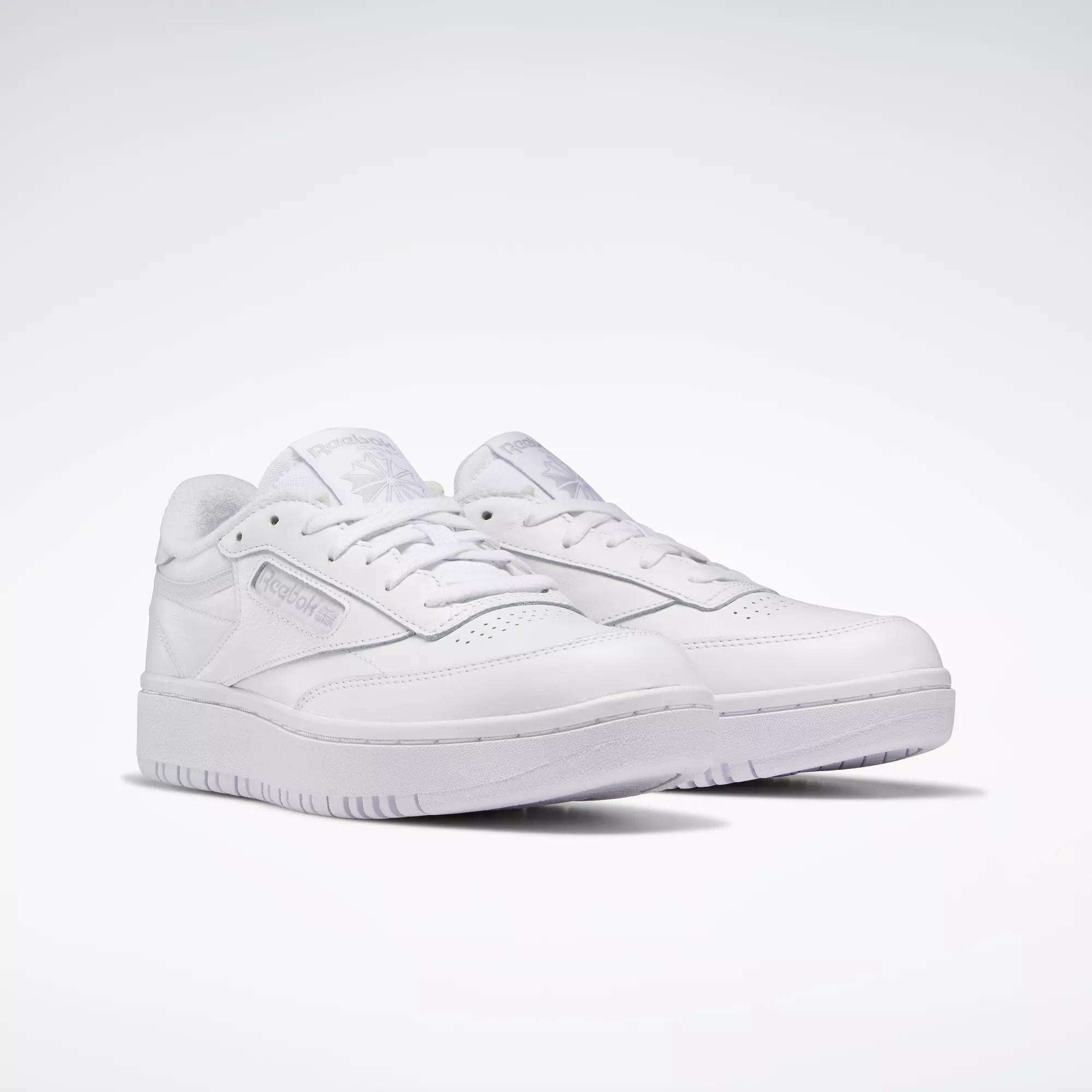 A pair of Reebok Women's Club C Double Shoes with low tops, laces, and subtle branding are displayed on a plain white background.