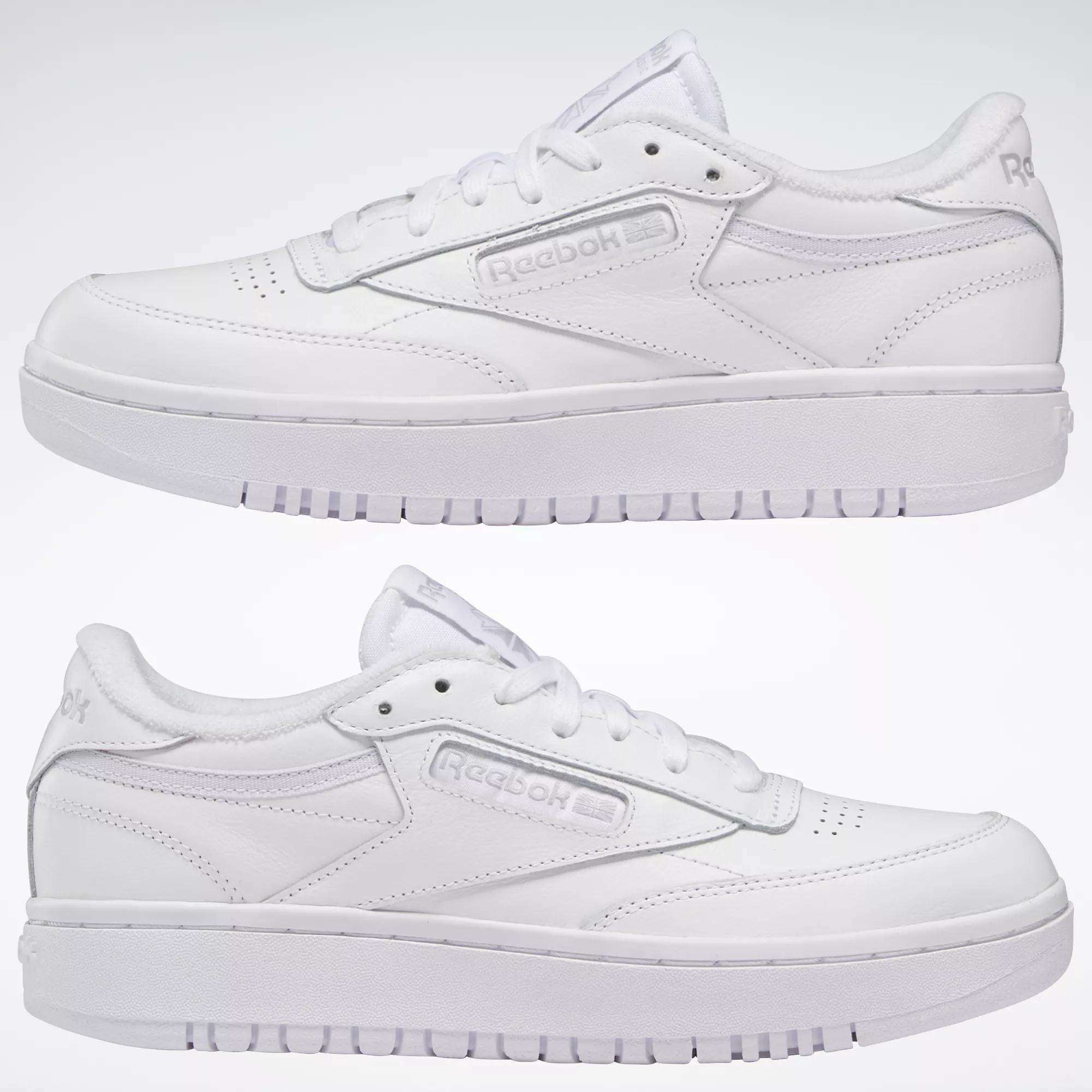 Two Women's Club C Double Shoes by Reebok are displayed side by side against a plain white background, highlighting their tennis-inspired side profiles with visible Reebok logos and classic stitching.