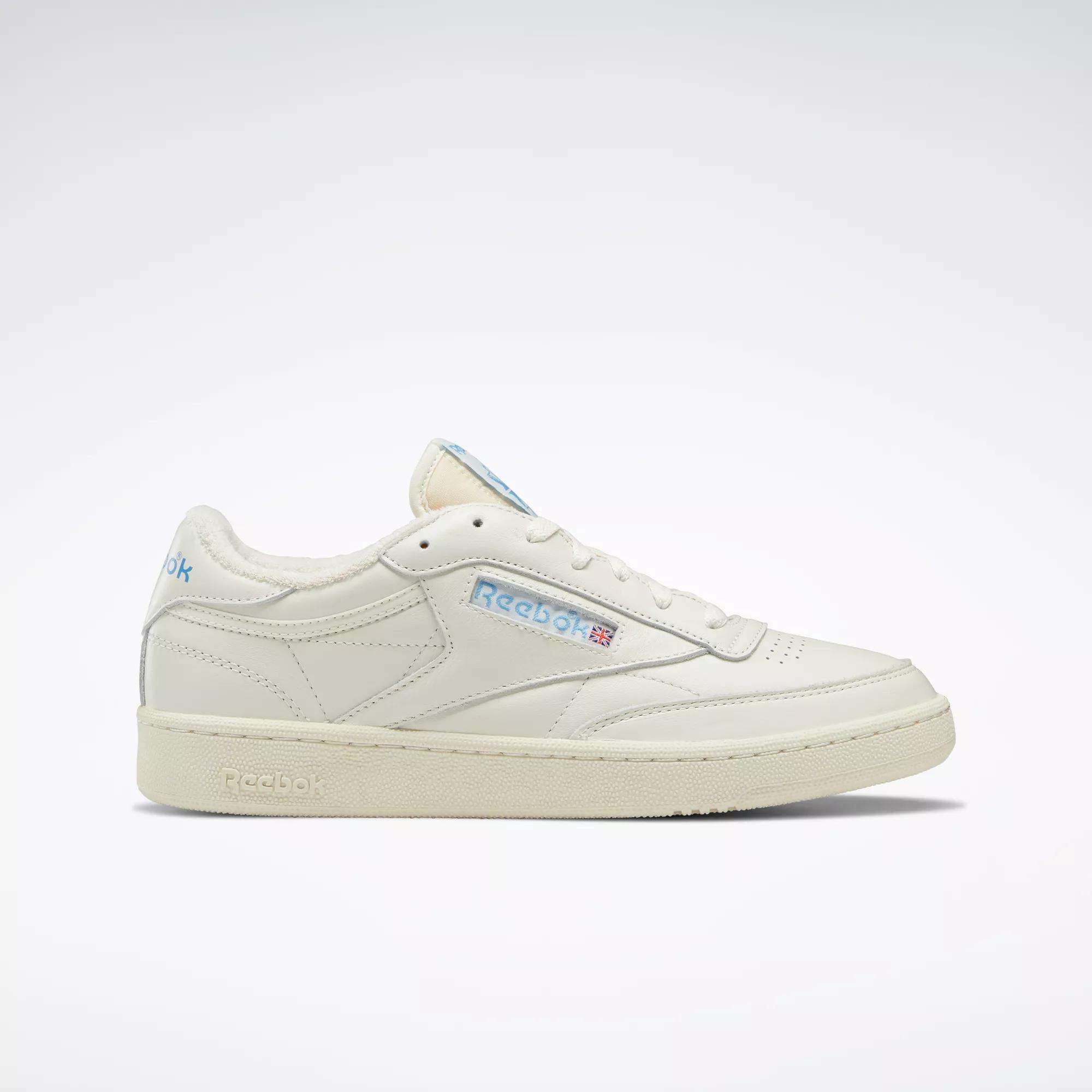 The Reebok Club C 85 Vintage Shoes feature a cream leather upper, blue accents, and a side Reebok logo, shown on a plain white background.
