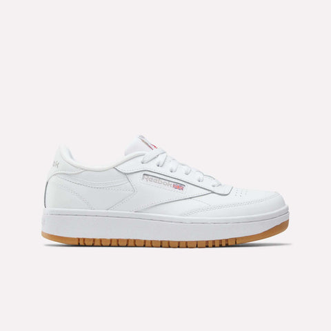 The Reebok Club C Double Shoes - Big Kids feature a white leather upper, low-top design, white laces, subtle Reebok branding, and a light brown gum sole, shown against a plain white background.