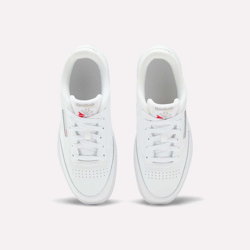The Reebok Club C Double Shoes for big kids feature a leather upper, white laces, and a red Reebok logo on the tongue—seen from above on a light background—making them the perfect classic girls' shoes.