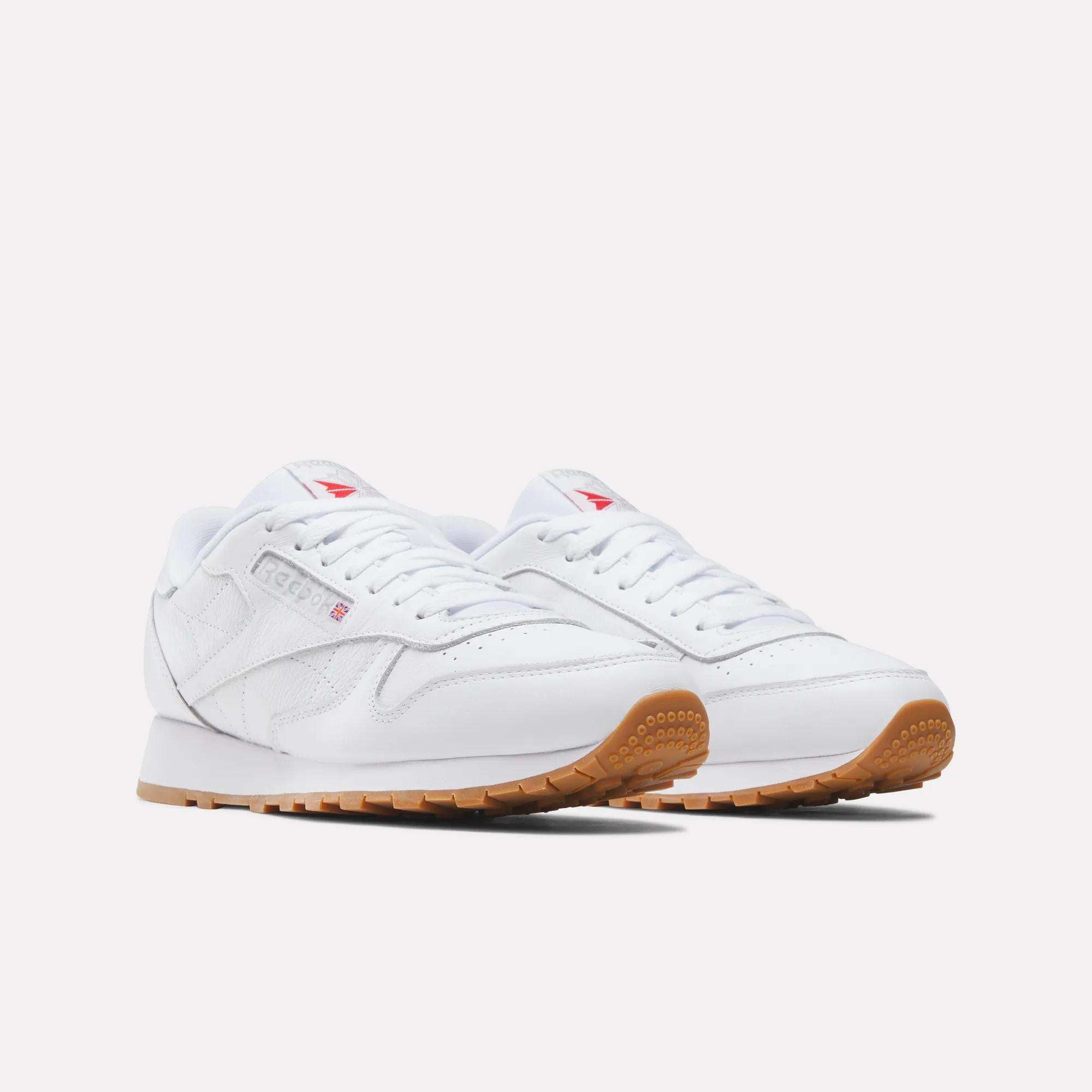 A pair of Reebok Classic Leather Shoes featuring a durable leather upper, gum rubber soles, white laces, and subtle side branding is displayed on a plain light background.