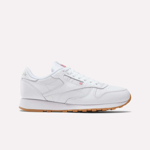 The Reebok Classic Leather Shoes feature a low-top design, white laces, subtle branding, and a tan rubber sole for timeless retro style, shown in side profile against a plain white background.