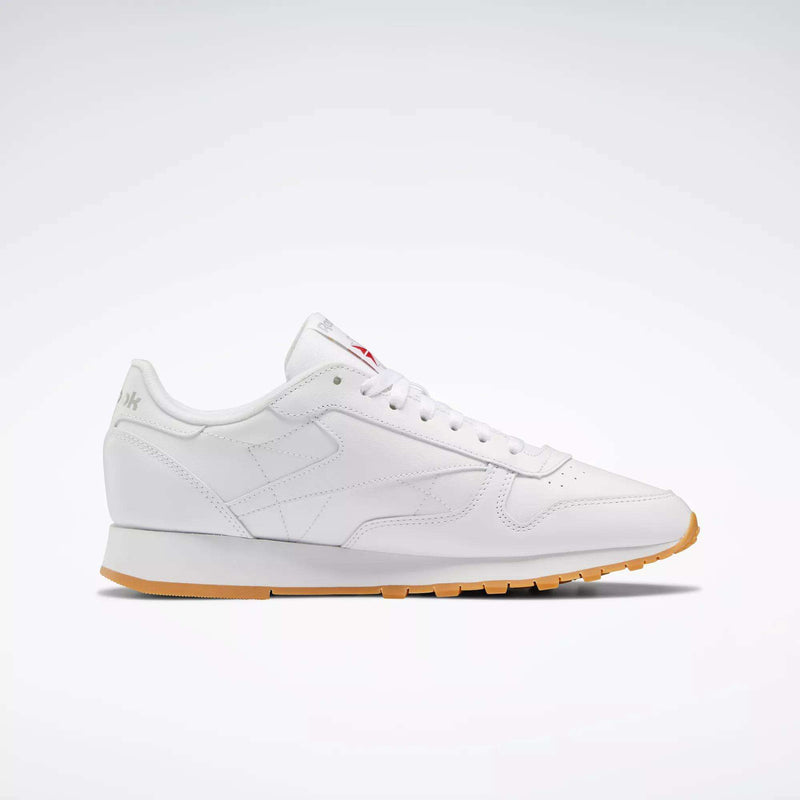 The Reebok Classic Leather Shoes are shown in a side profile on a plain light background, featuring a white leather upper, gum sole, white laces, and subtle stitching that highlight their retro style and durable construction.