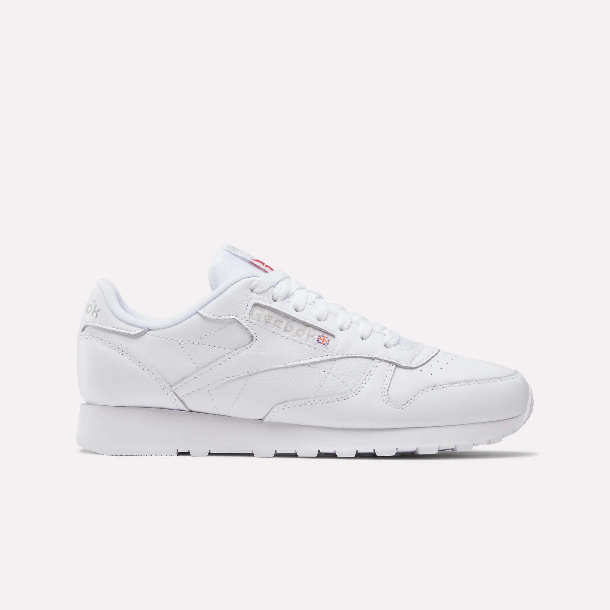 The Reebok Classic Leather Shoes feature a white leather upper, minimal stitching, and subtle side and heel branding, displayed in retro style from a side view against a light background.