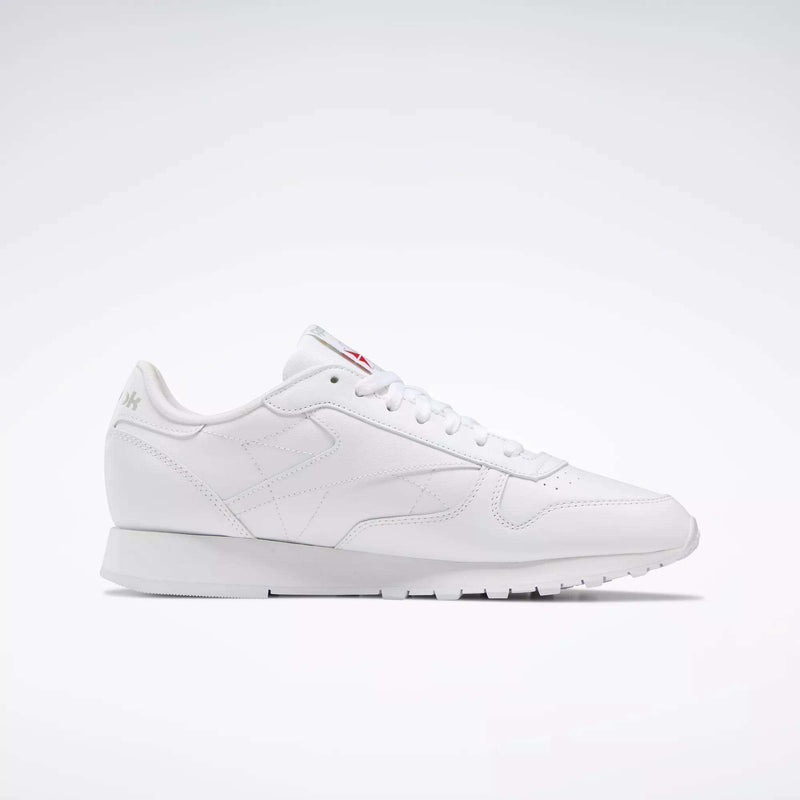 The Reebok Classic Leather Shoes are white low-top sneakers inspired by retro designs, with white laces and subtle branding, shown against a simple light background.