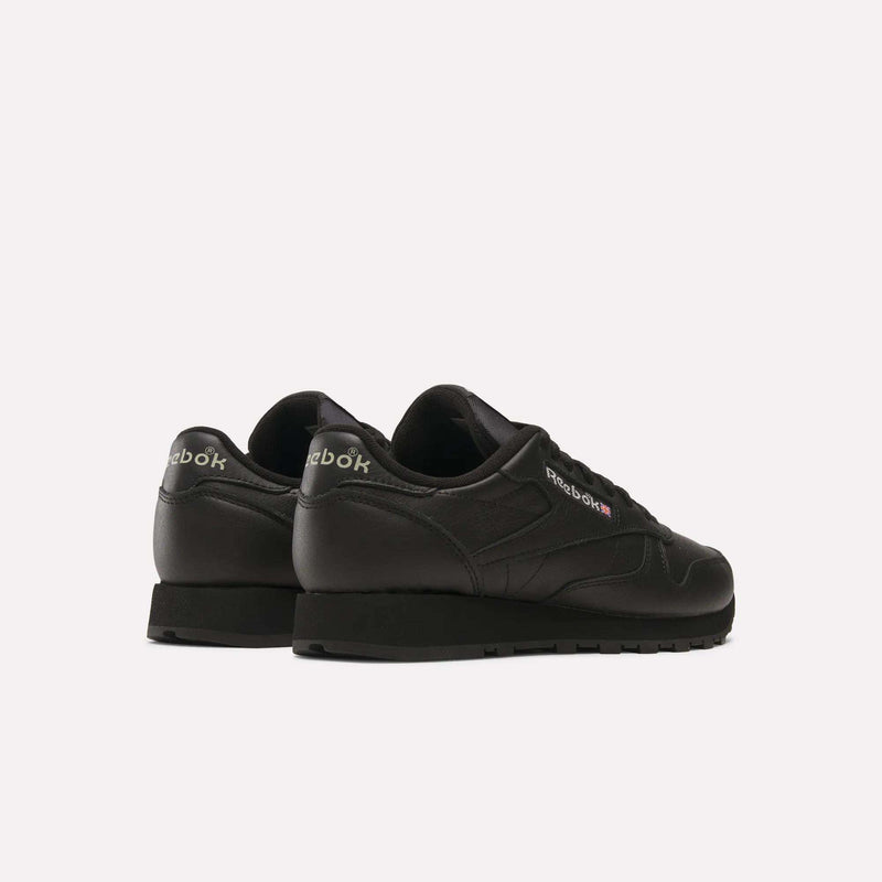 A pair of Reebok Classic Leather Shoes in black is shown from the back and side on a white background, displaying the Reebok logo on the heel and side of each retro-inspired sneaker.