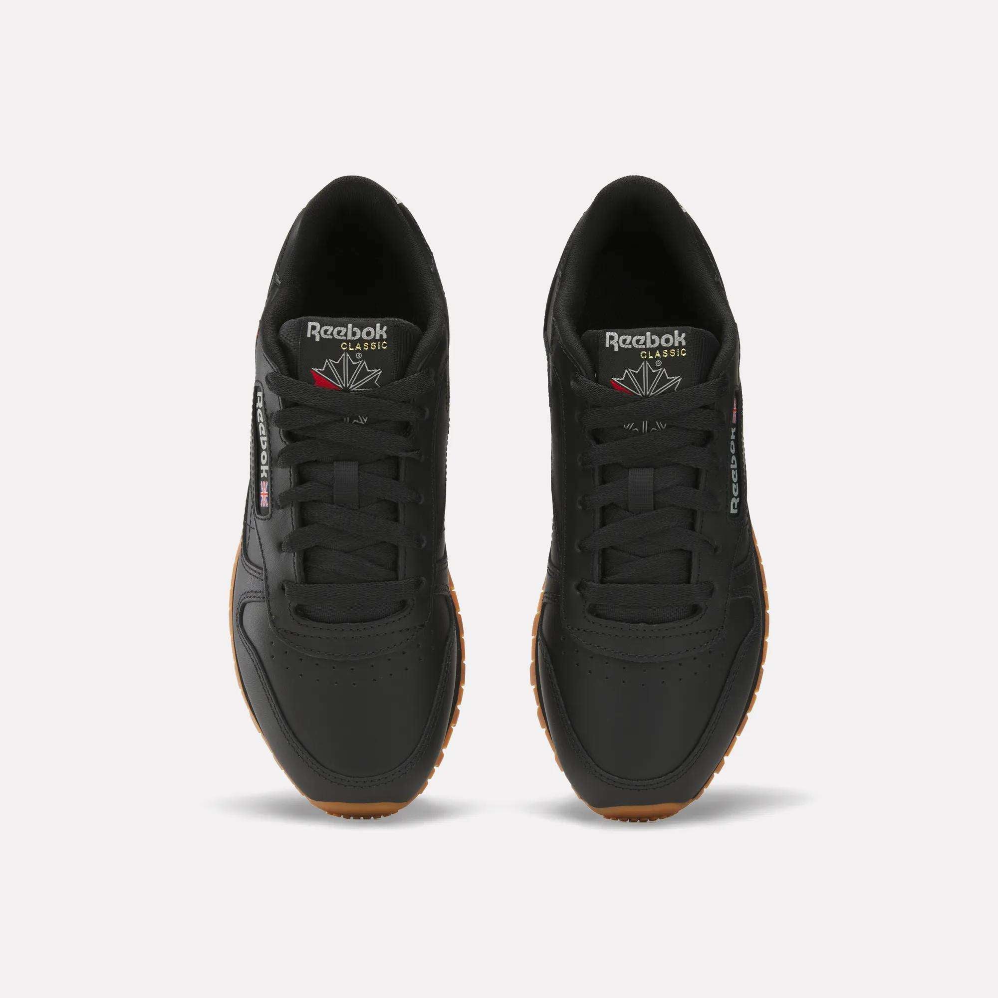 A pair of Women's Classic Leather Shoes by Reebok with cushioned midsoles and gum soles, shown from above on a plain white background. The shoes display Reebok branding on the tongue and side.