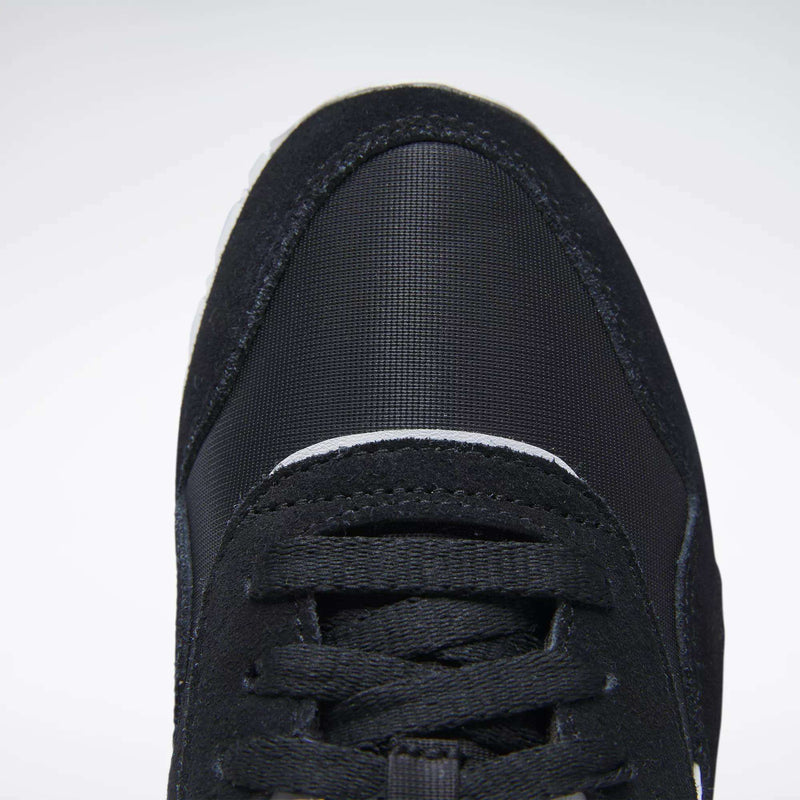 Close-up top view of the front of a black Reebok Women's Classic Nylon Shoe with black laces and a textured, rounded toe cap, shown against a plain white background.