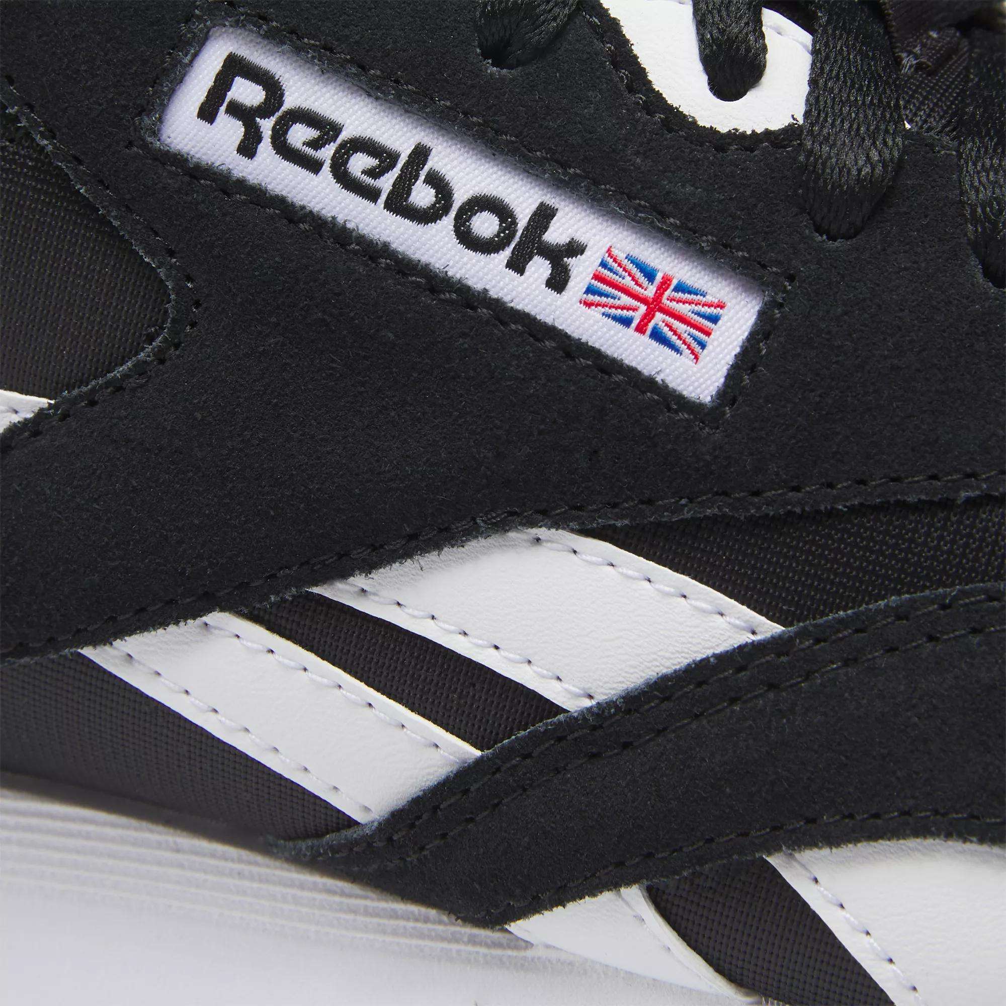 Close-up of a black Men's Classic Nylon Shoe by Reebok, featuring white stripes and the logo with the Union Jack flag on the side—ideal for fans of classic sneakers and everyday wear.