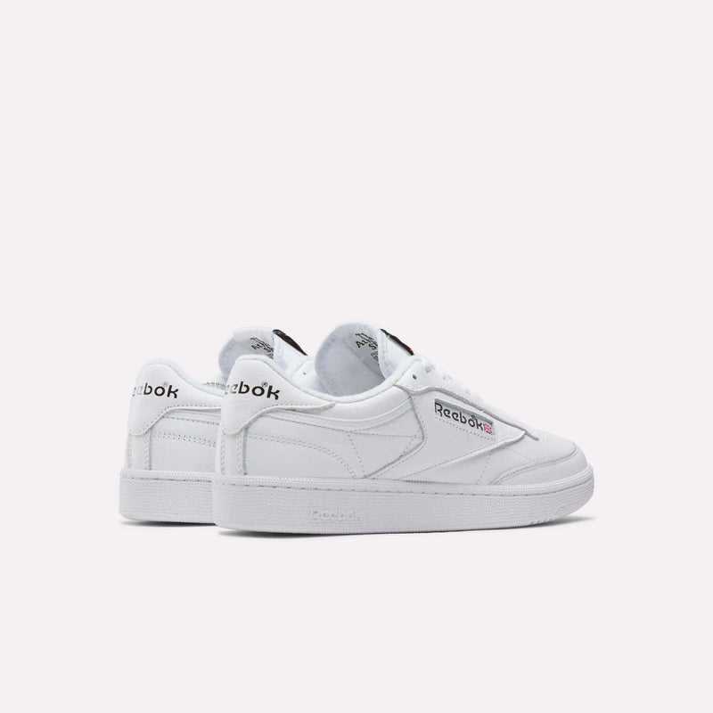 Two white Reebok Club C 85 Shoes are displayed on a plain light background, angled to show the side and heel with the Reebok logo, highlighting their classic tennis-inspired leather design.