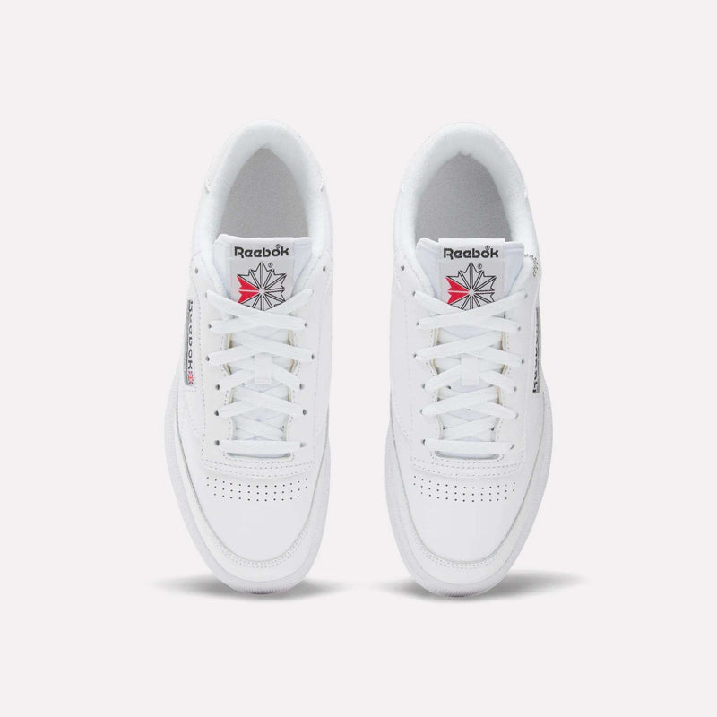 A top view of white Reebok Club C 85 Shoes showing perforated toe detailing and a tongue with the Reebok logo in red and gray.